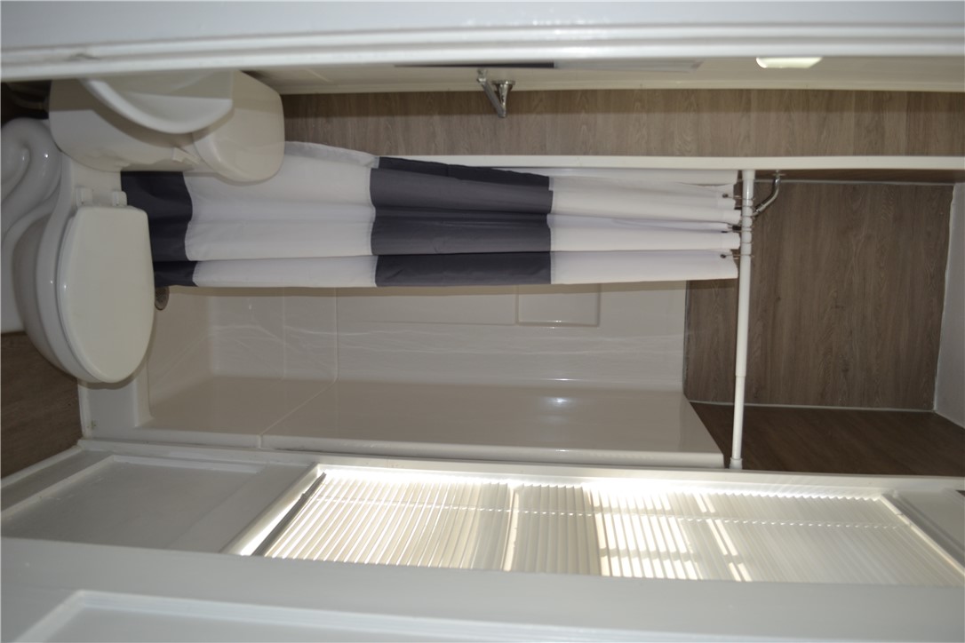 205 B East Broad Street Anderson, SC 29621 - Photo 9 of 27 This functional bathroom features a shower, toilet, and window with blinds for natural light.