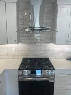 a stove top oven sitting inside of a kitchen