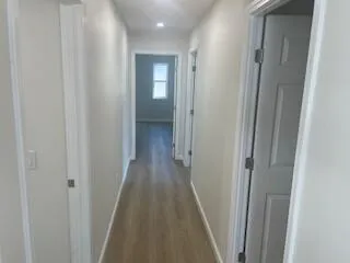 a view of a hallway with a wooden door