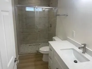 a bathroom with a sink toilet and shower