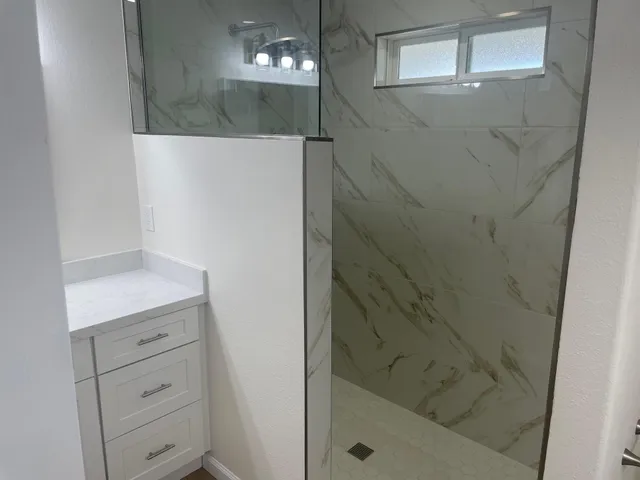 a bathroom with a shower and a sink