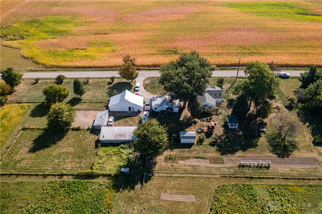 1599 Garringer Road Jamestown, OH 45335 - Photo 69 of 73 An aerial view showcases a charming rural homestead amidst vast fields.