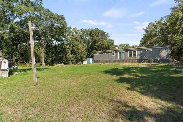 a backyard of a house with trampoline