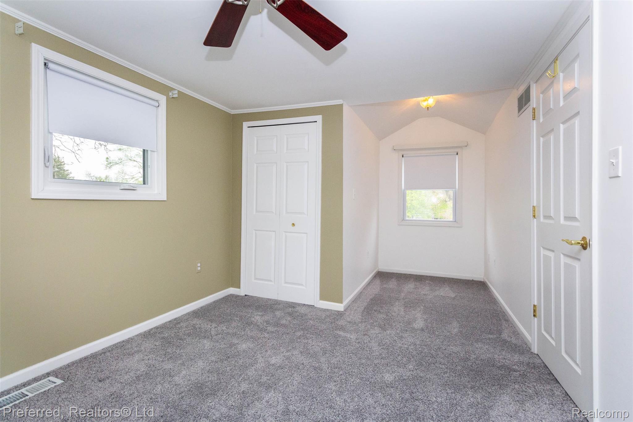 9840 Currie Road Northville, MI 48167 - Photo 26 of 62 Unfurnished bedroom featuring carpet flooring, a closet, vaulted ceiling, ceiling fan, and crown molding