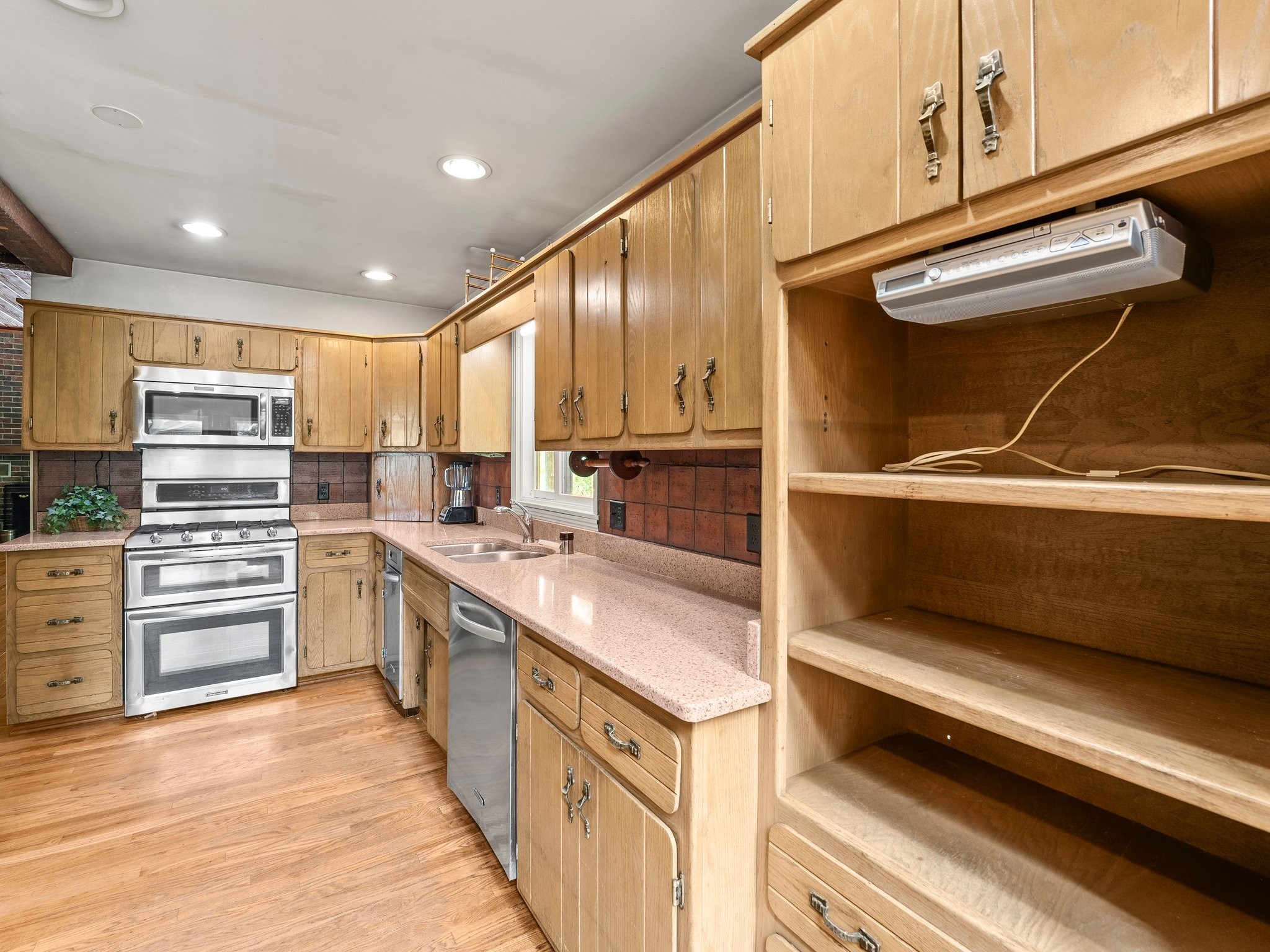 144 Wood Bluff Road Winchester, TN 37398 - Photo 19 of 63 a kitchen with stainless steel appliances kitchen island granite countertop a refrigerator and cabinets