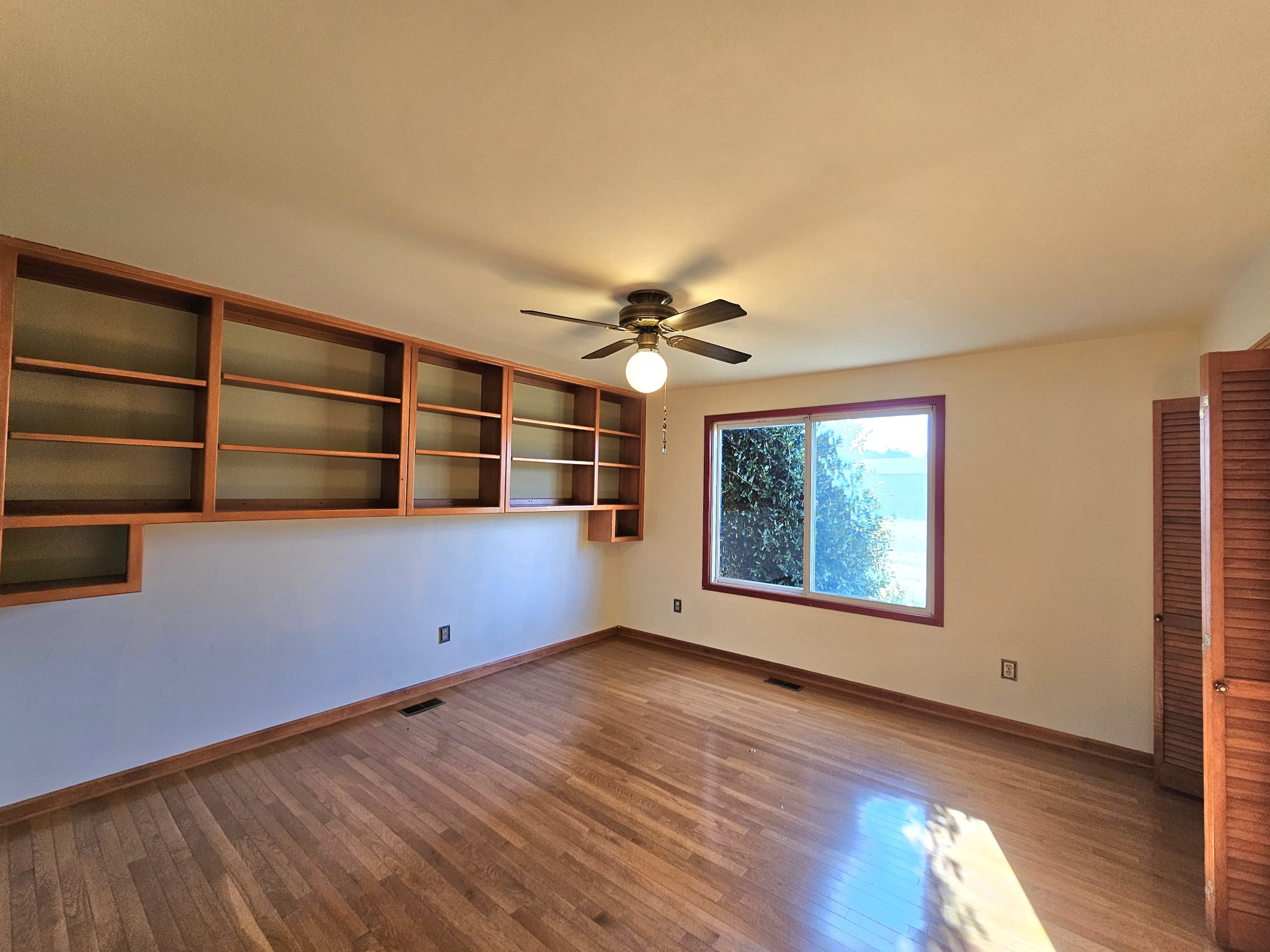 144 Wood Bluff Road Winchester, TN 37398 - Photo 26 of 63 a view of an empty room with wooden floor and a window