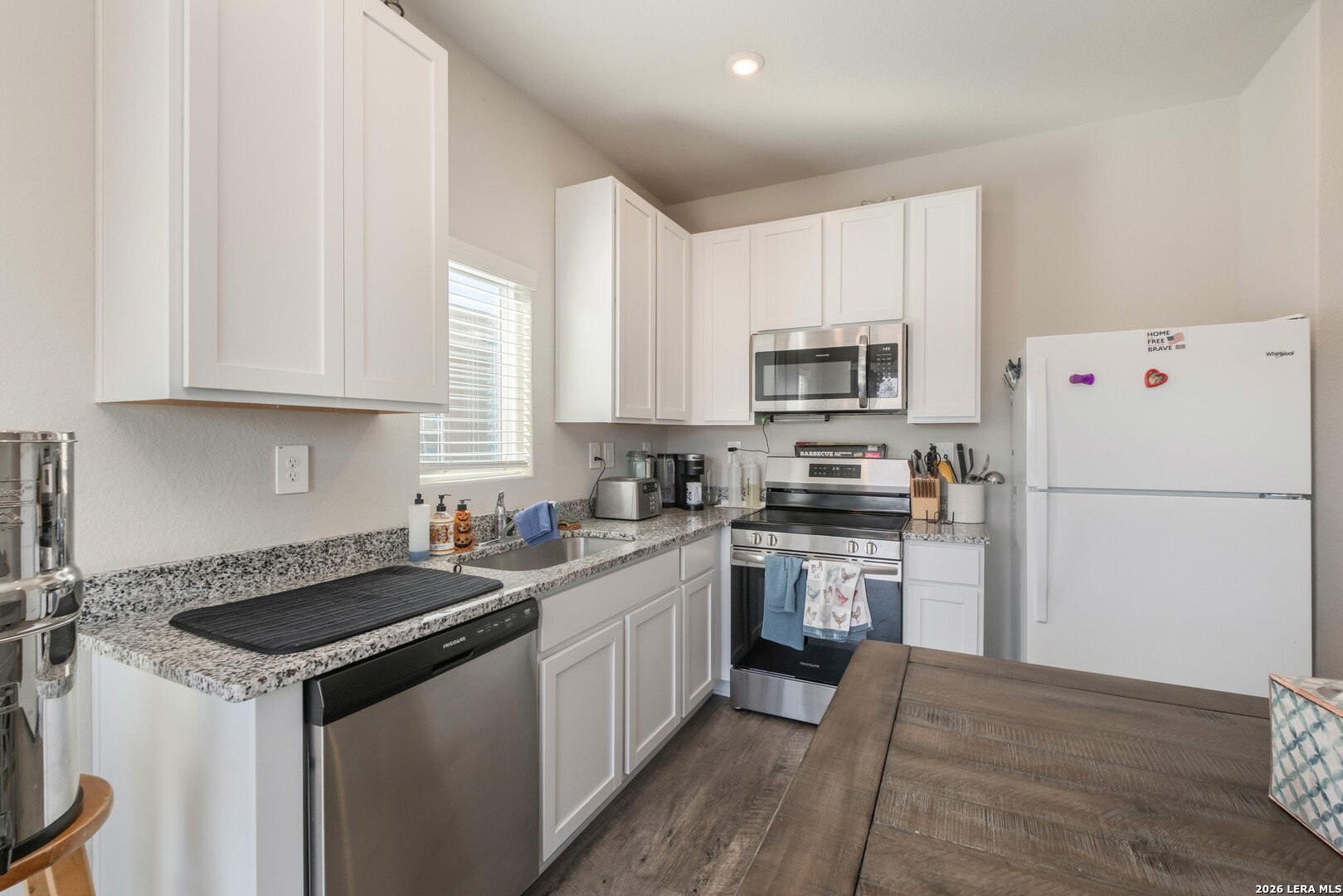 3505 Sky Place Seguin, TX 78155 - Photo 16 of 30 a kitchen with a sink a stove a microwave and refrigerator