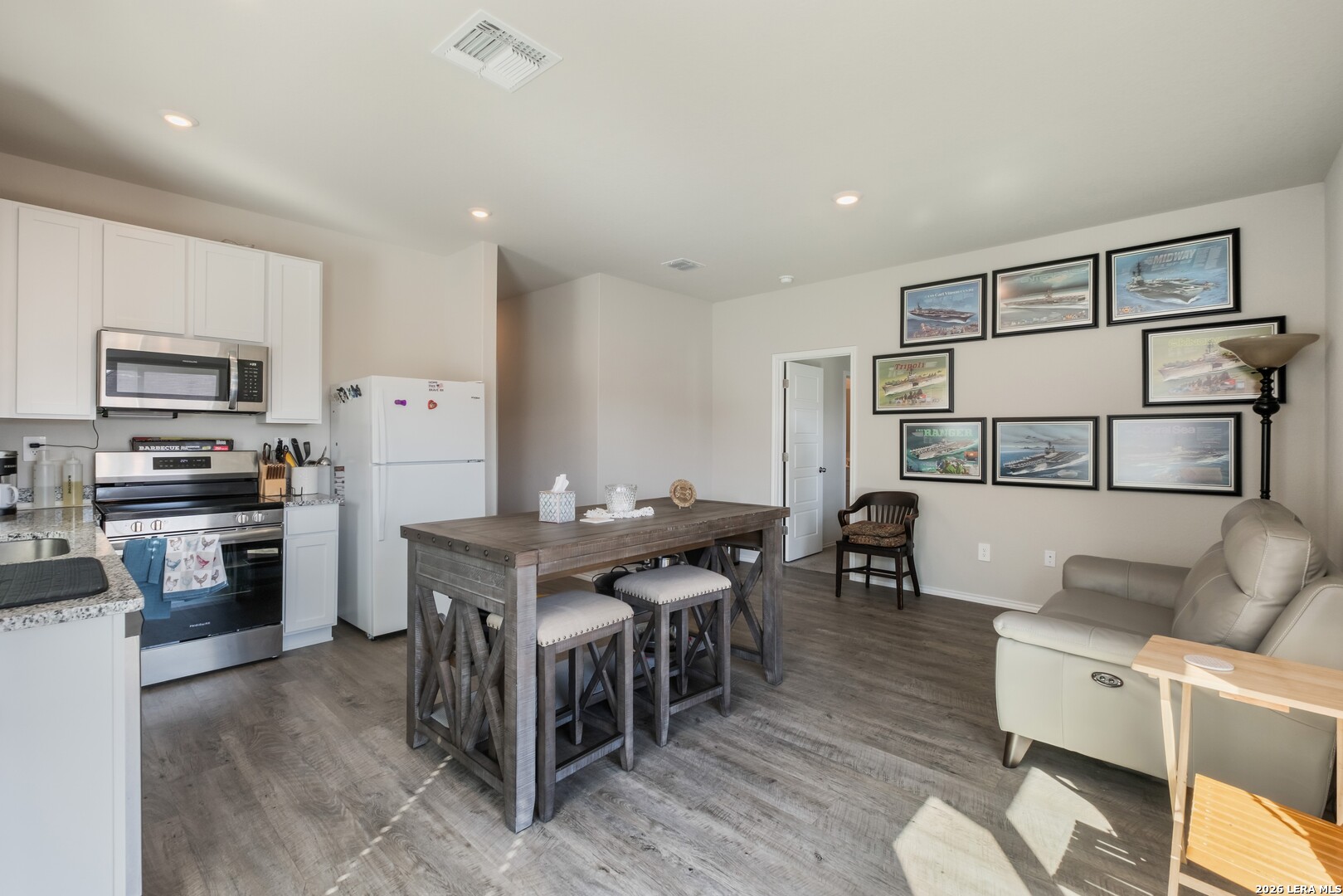 3505 Sky Place Seguin, TX 78155 - Photo 18 of 30 a living room with stainless steel appliances kitchen island granite countertop a table chairs and a refrigerator