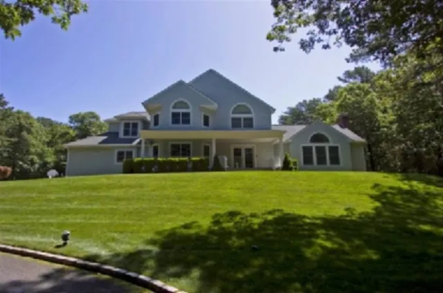 a front view of a house with garden