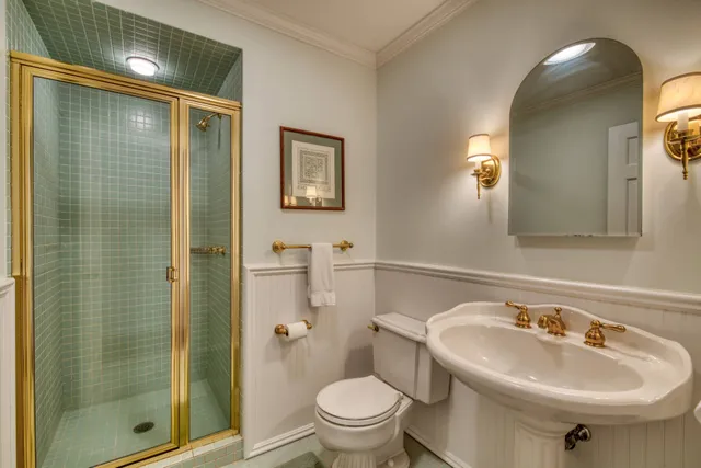 a bathroom with a sink toilet and shower