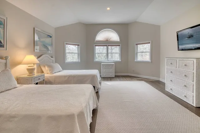 a bedroom with two beds and a flat screen tv