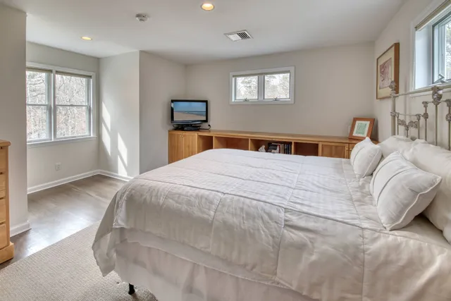 a bedroom with a large bed and a window