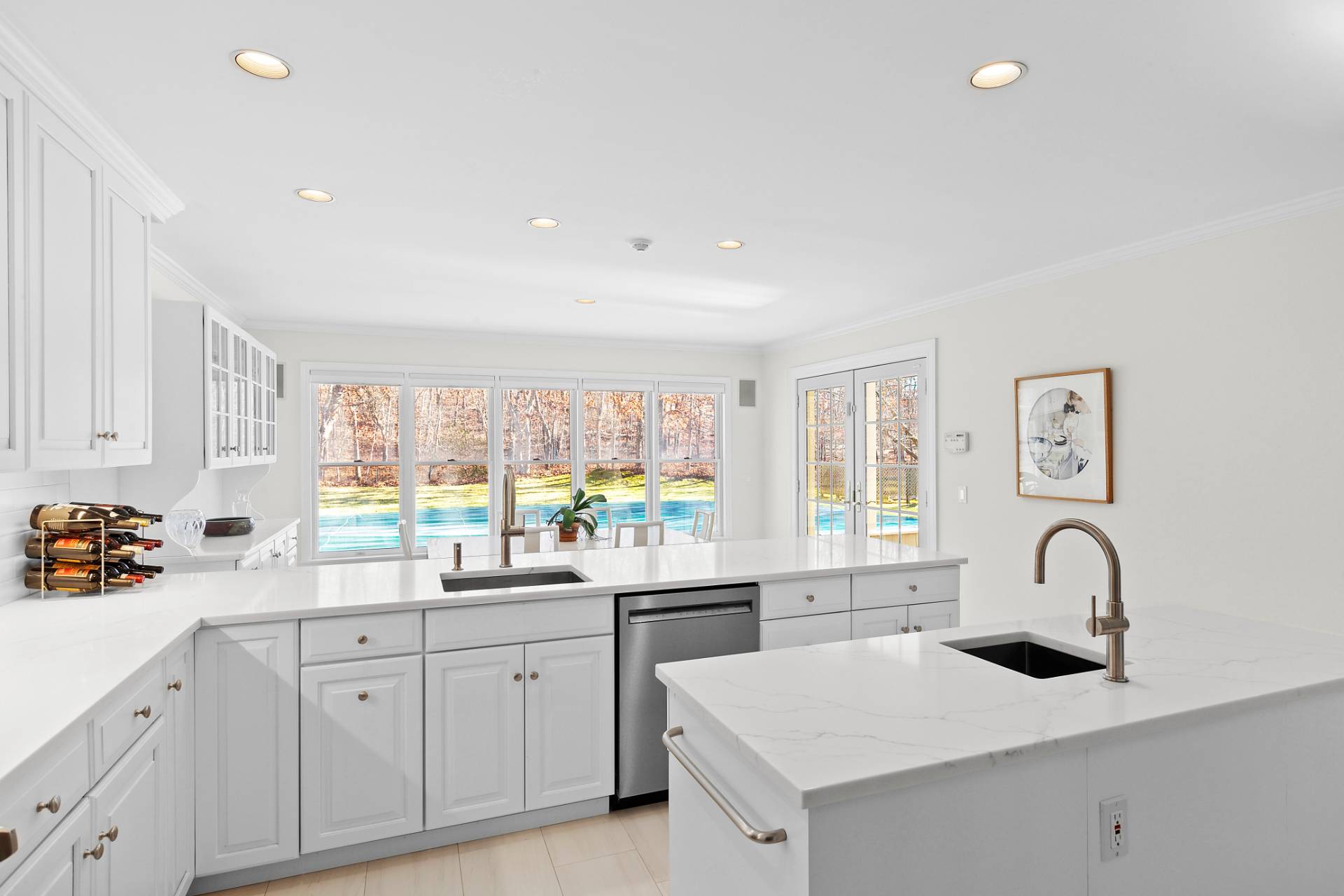 1611 Deerfield Road Water Mill, NY 11976 - Photo 4 of 22 a kitchen with white cabinets a sink appliances and a counter top space