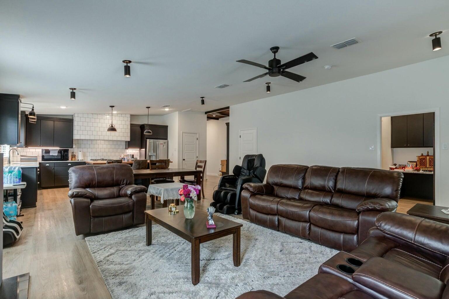 3711 128th Street Lubbock, TX 79423 - Photo 14 of 42 a living room with furniture and a flat screen tv with kitchen view