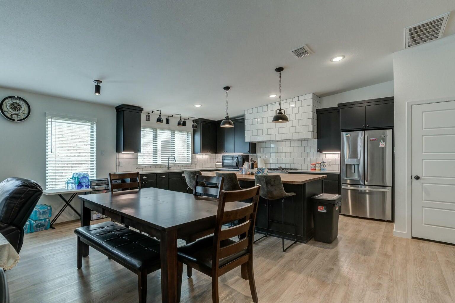 3711 128th Street Lubbock, TX 79423 - Photo 17 of 42 a kitchen with a table chairs sink and cabinets