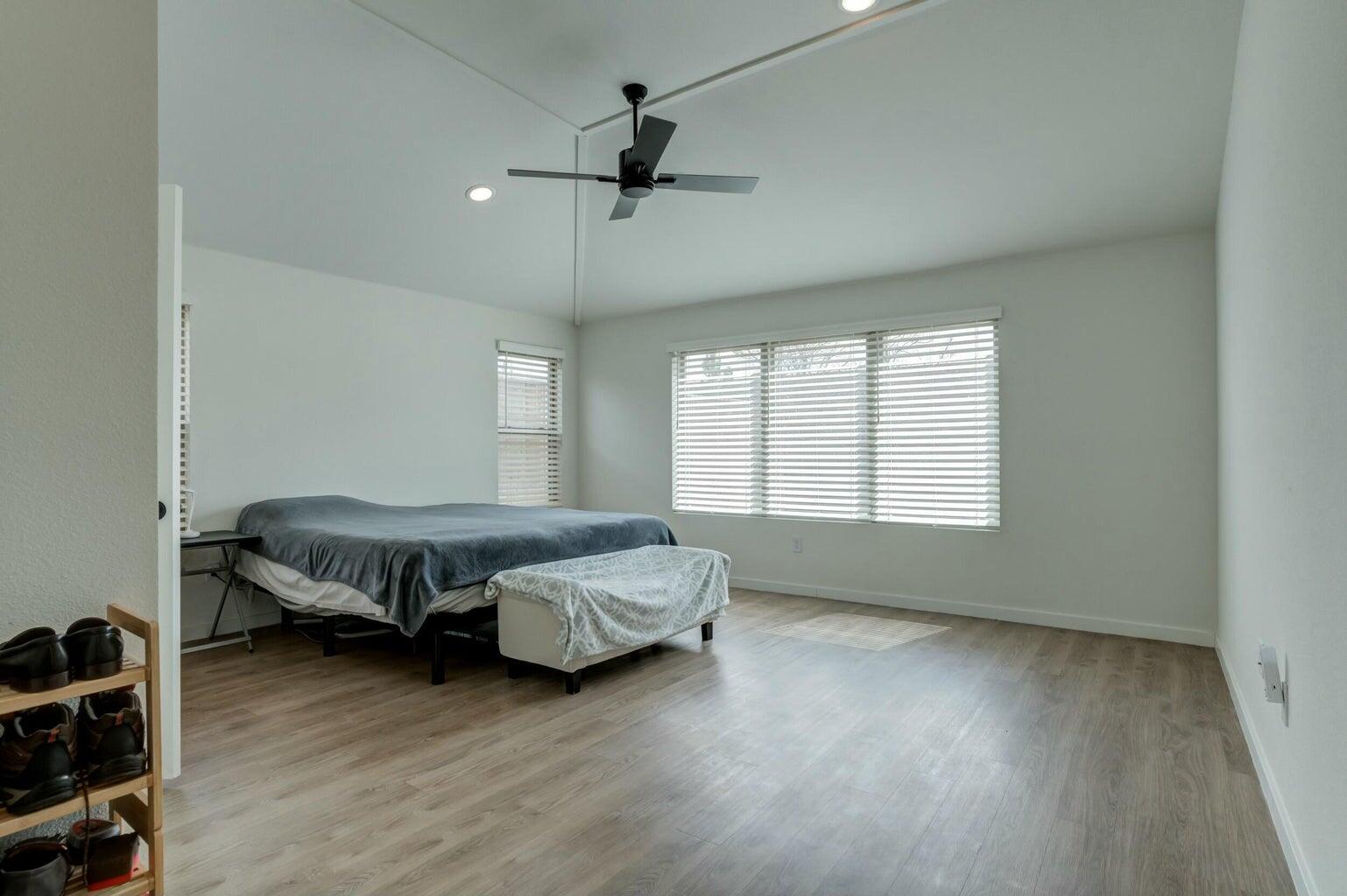 3711 128th Street Lubbock, TX 79423 - Photo 19 of 42 a spacious bedroom with a bed and wooden floor