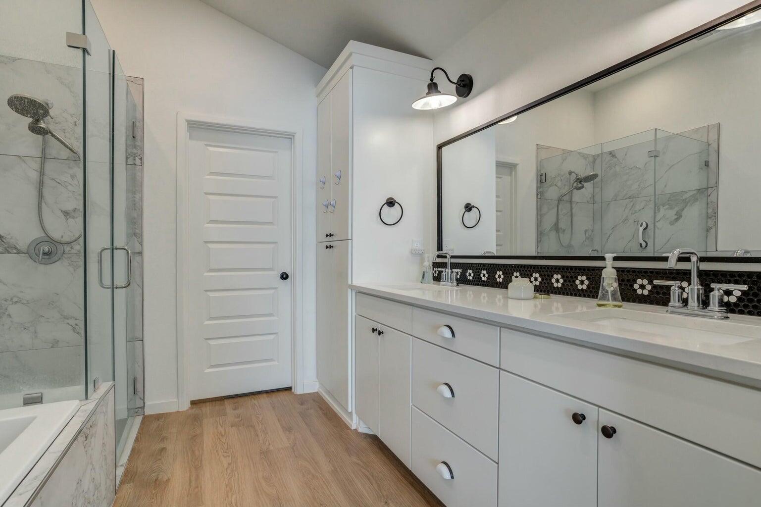 3711 128th Street Lubbock, TX 79423 - Photo 22 of 42 a spacious bathroom with a double vanity sink a mirror and a shower