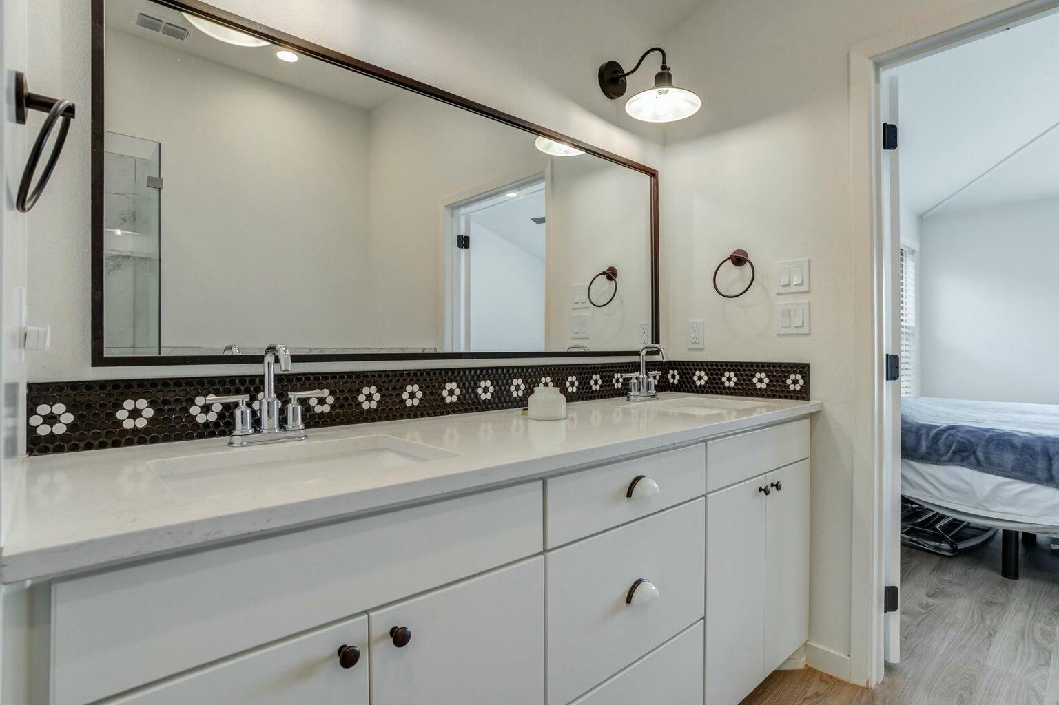 3711 128th Street Lubbock, TX 79423 - Photo 25 of 42 a bathroom with a sink and a mirror