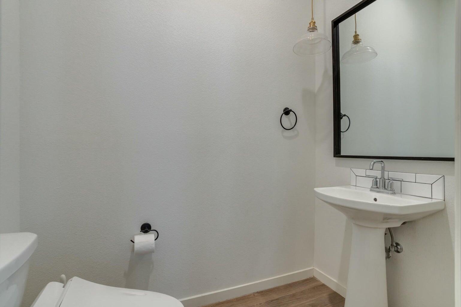 3711 128th Street Lubbock, TX 79423 - Photo 26 of 42 a bathroom with a sink toilet and mirror
