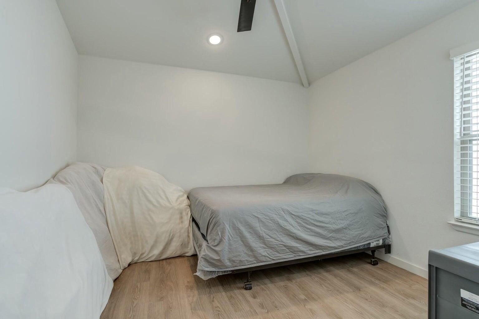 3711 128th Street Lubbock, TX 79423 - Photo 27 of 42 a room with a bed and a wooden floor