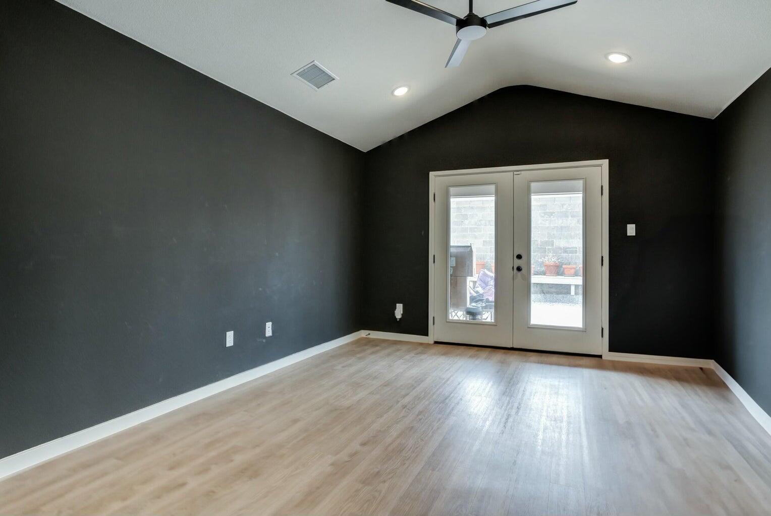 3711 128th Street Lubbock, TX 79423 - Photo 33 of 42 a view of an empty room with a window and wooden floor