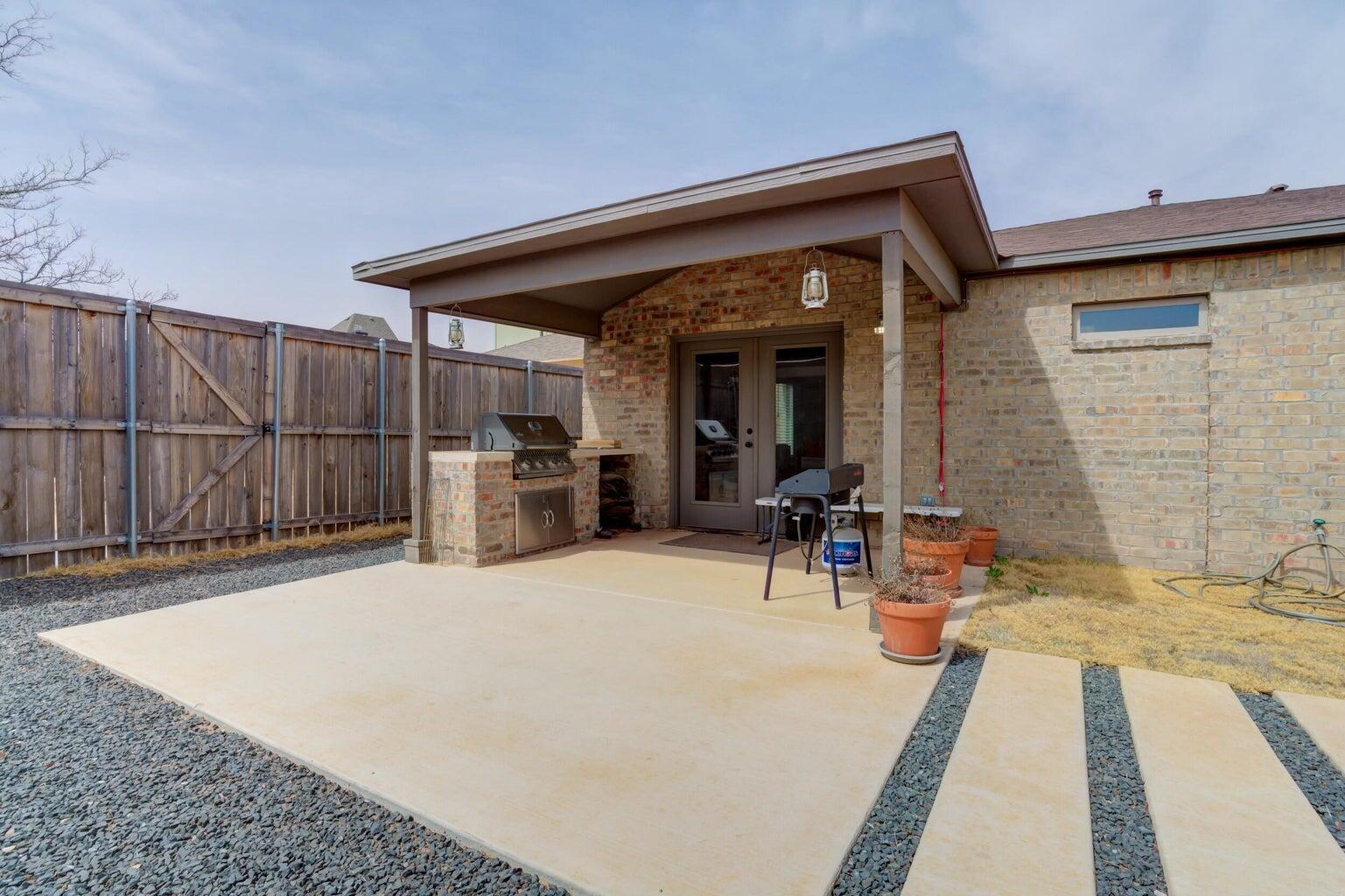3711 128th Street Lubbock, TX 79423 - Photo 38 of 42 a view of a house with chairs in patio