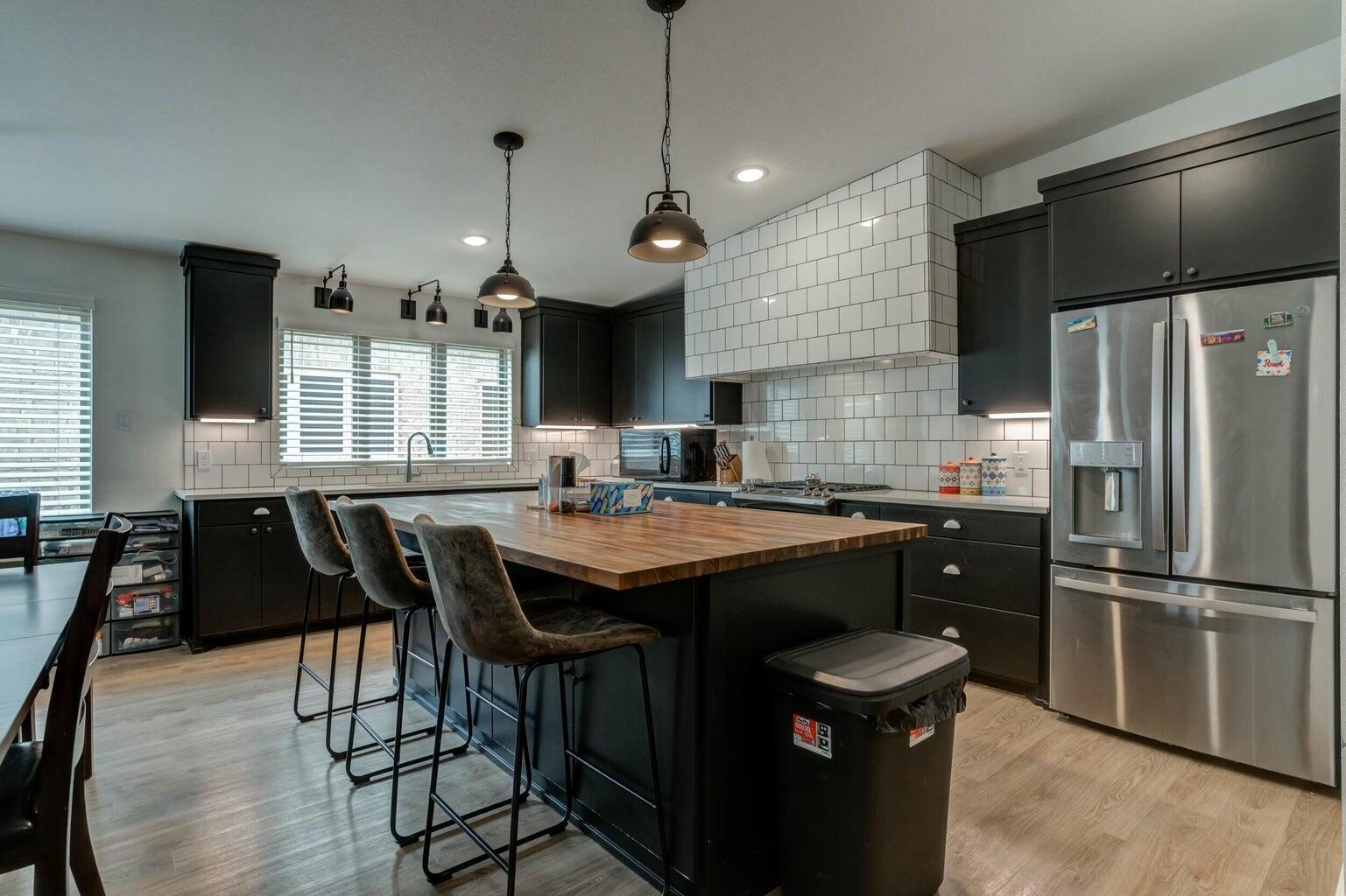 3711 128th Street Lubbock, TX 79423 - Photo 5 of 42 a kitchen with stainless steel appliances granite countertop a sink a stove and a refrigerator