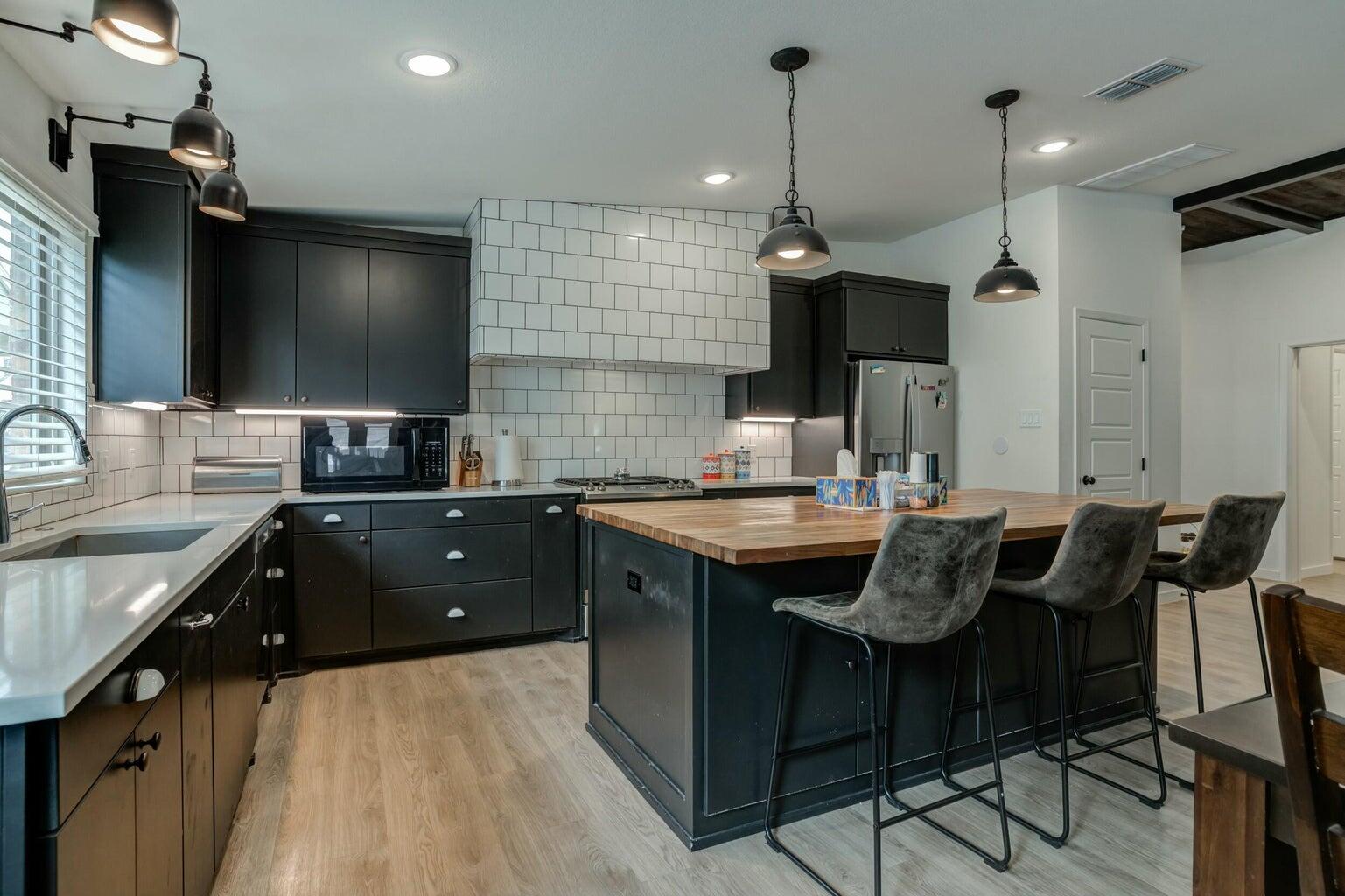 3711 128th Street Lubbock, TX 79423 - Photo 6 of 42 a kitchen with a counter space a sink and cabinets