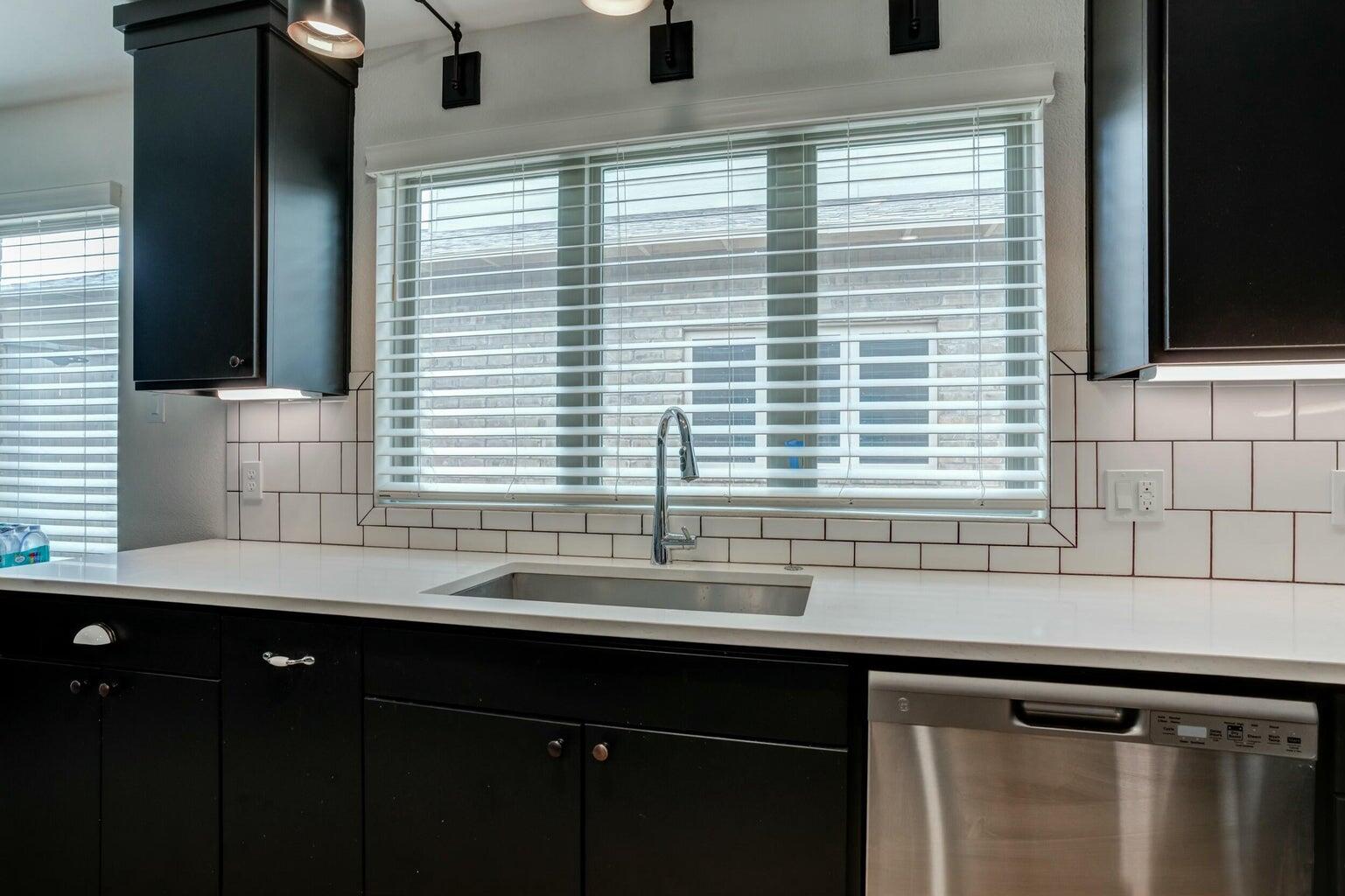 3711 128th Street Lubbock, TX 79423 - Photo 8 of 42 a kitchen with a sink and a window
