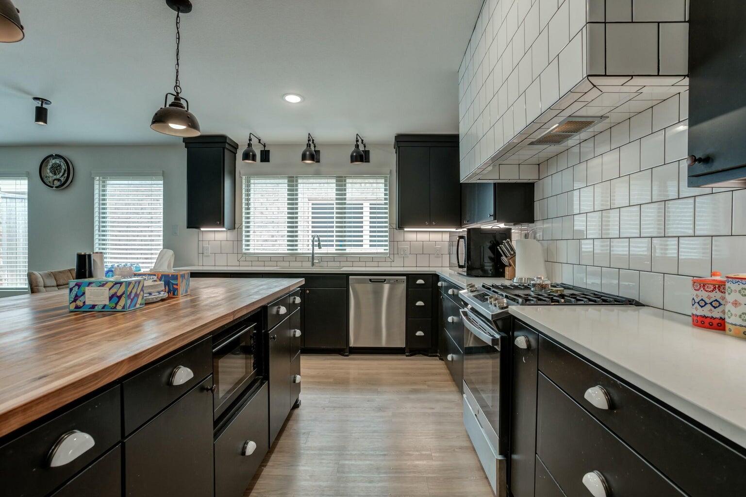 3711 128th Street Lubbock, TX 79423 - Photo 9 of 42 a kitchen with a sink stove and cabinets
