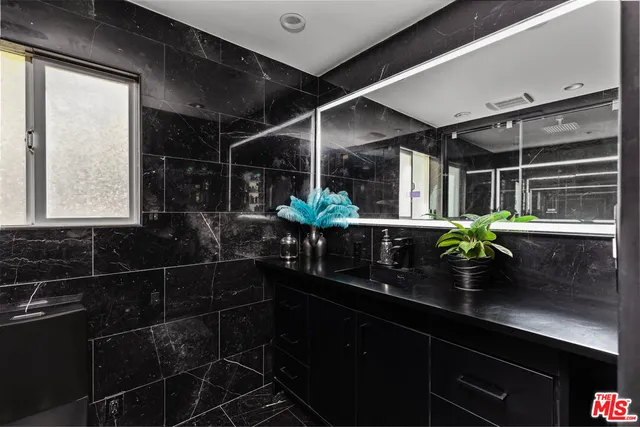 a kitchen with stainless steel appliances kitchen island granite countertop a sink and cabinets