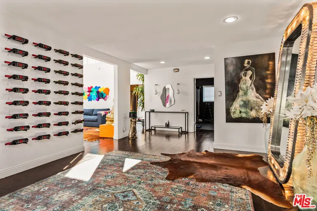 a room with lots of white furniture and garden view