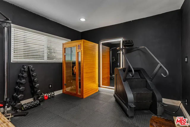 a room with gym equipment and a mirror