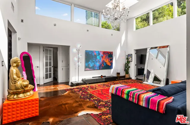 a living room with furniture and a chandelier