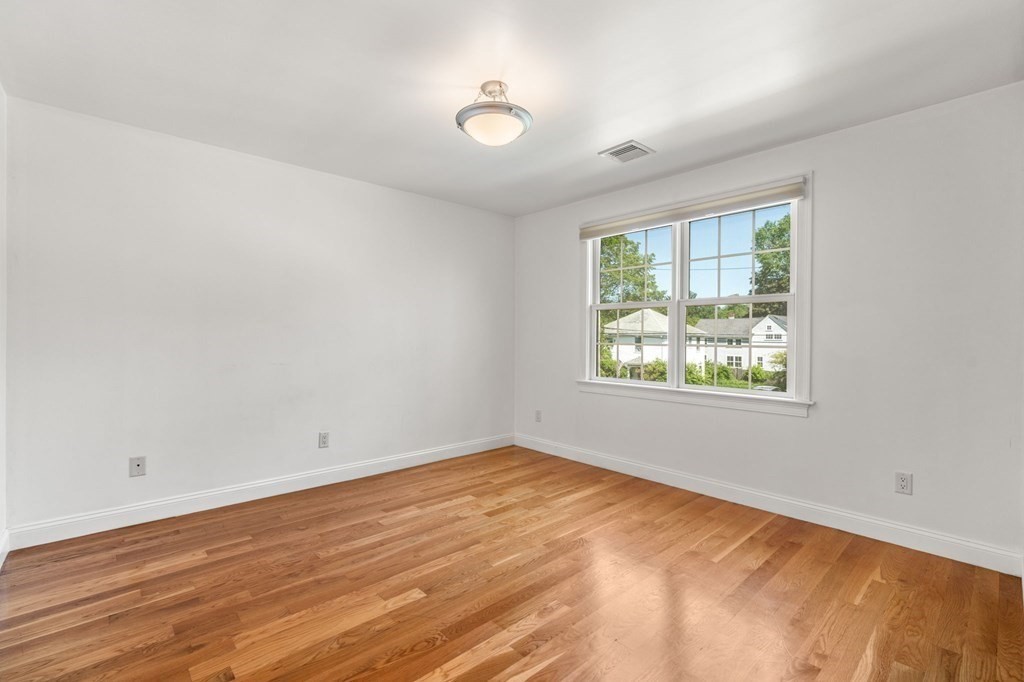 3 Bryn Mawr Road Wellesley, MA 02482 - Photo 22 of 38 an empty room with wooden floor and windows