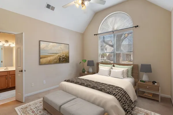 a bedroom with a large bed and a window