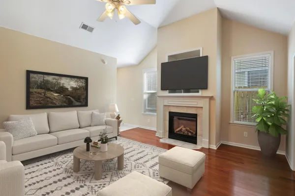 a living room with furniture a flat screen tv and a fireplace