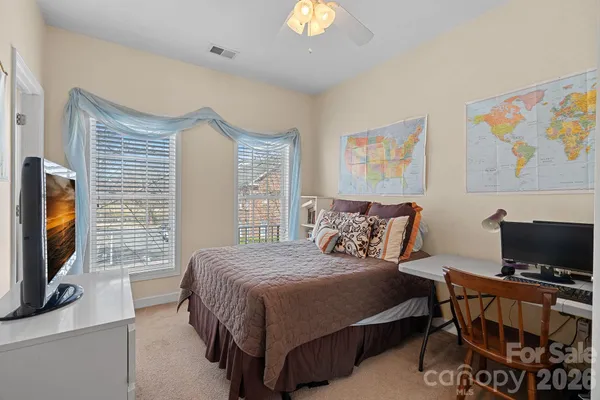 a bedroom with a bed and flat screen tv