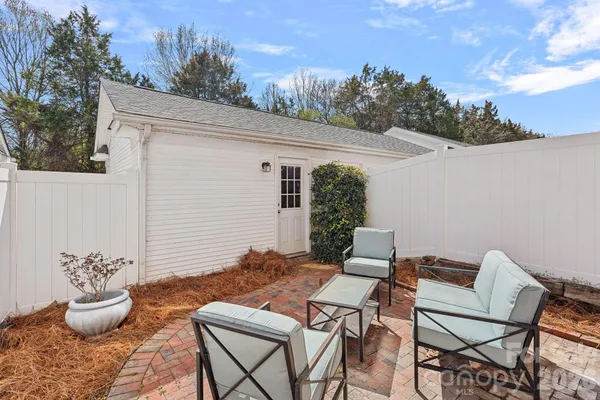 a backyard of a house with table and chairs
