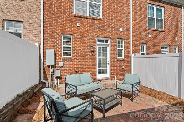 a balcony with chairs and a table