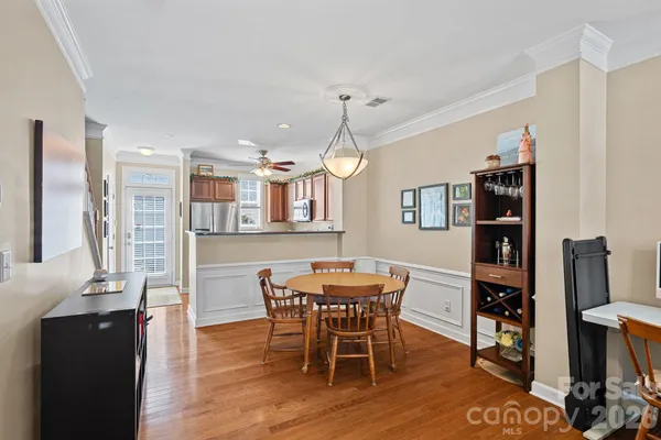 a view of a dining room with furniture and wooden floor