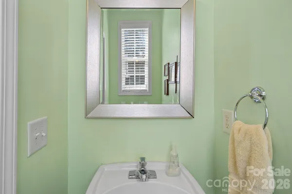a bathroom with a sink a window and a mirror
