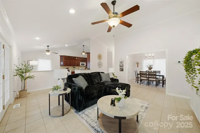 a living room with furniture and kitchen view