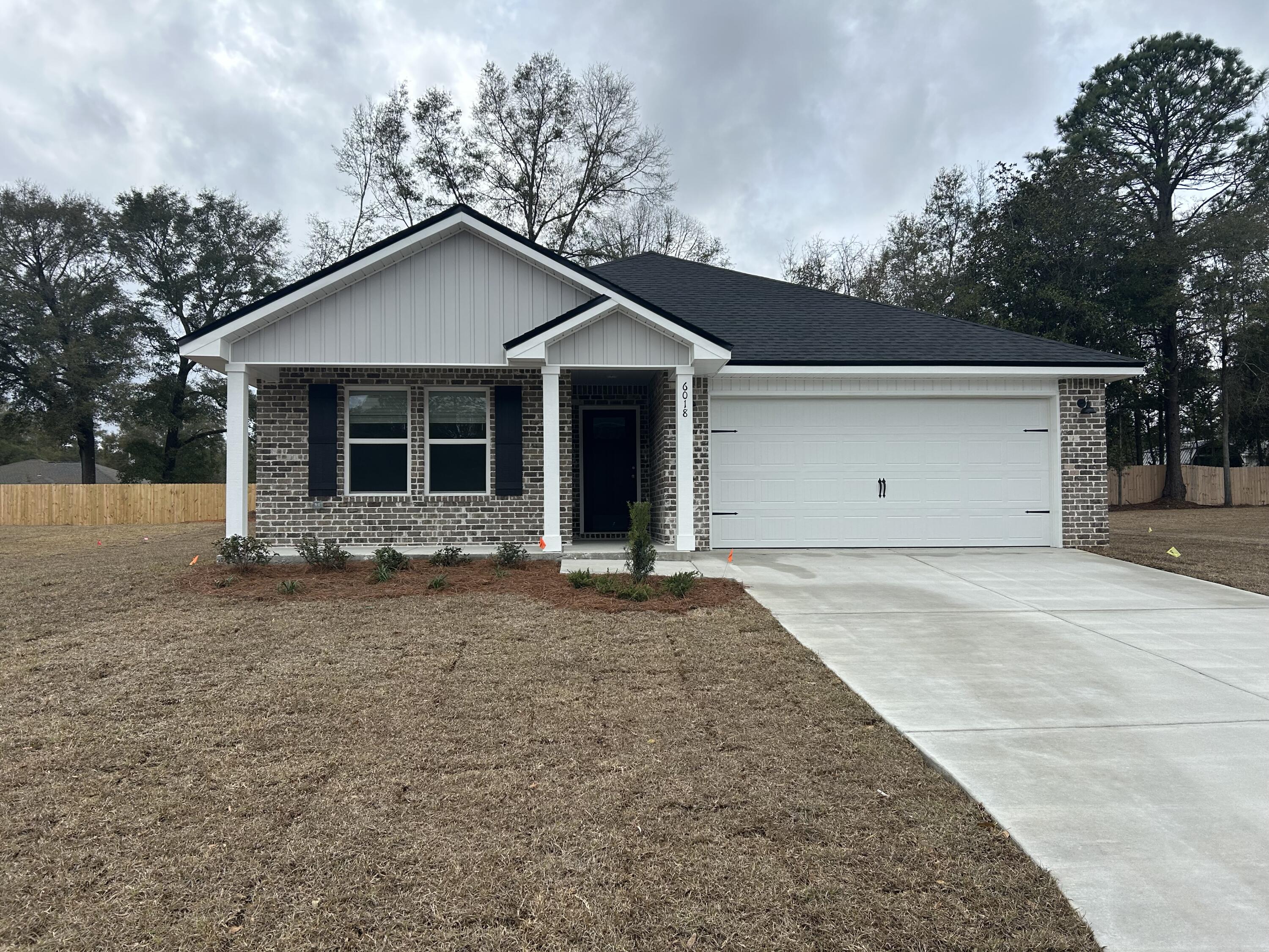 a view of a house with a yard and garage