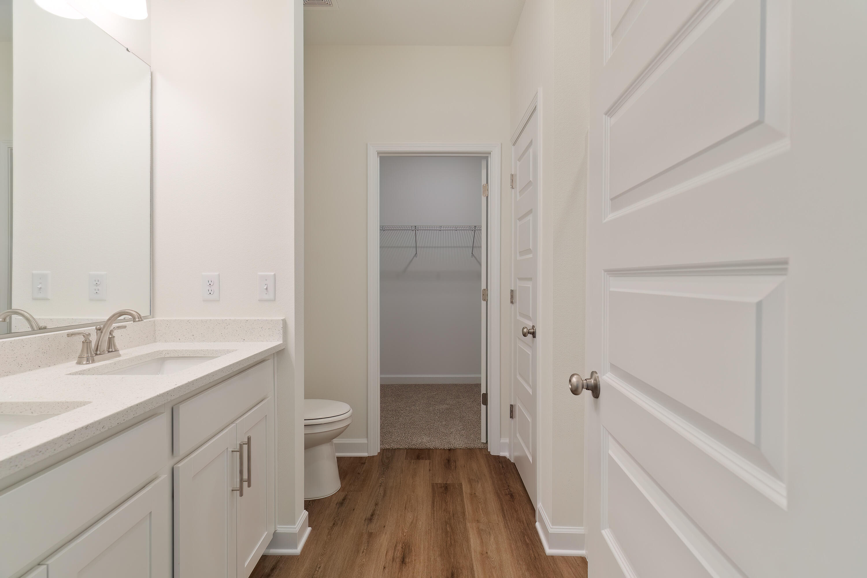 6018 Oak Hollow Way Crestview, FL 32539 - Photo 11 of 18 a bathroom with a sink a toilet and a large mirror