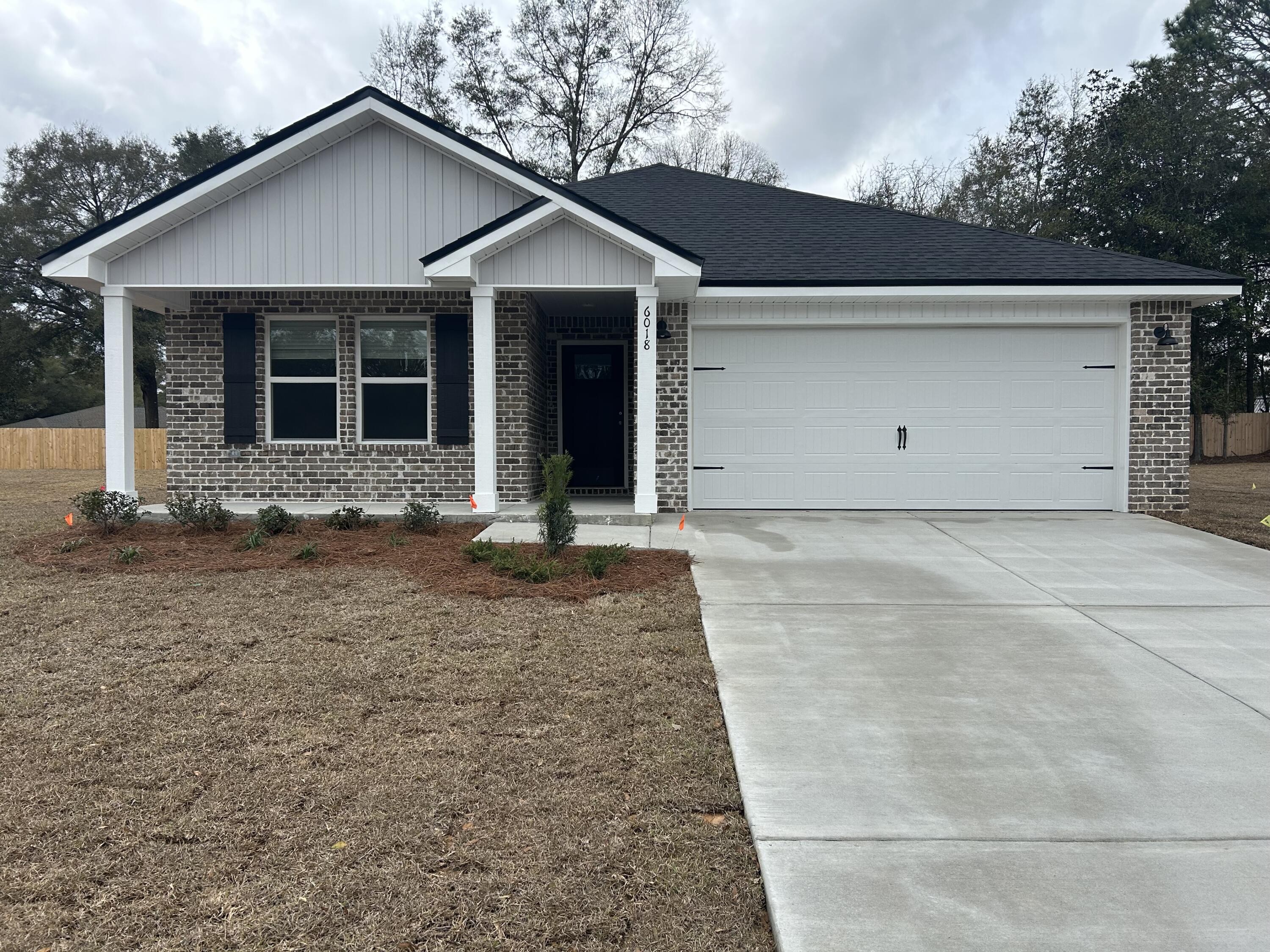 6018 Oak Hollow Way Crestview, FL 32539 - Photo 18 of 18 a front view of a house with a yard and garage