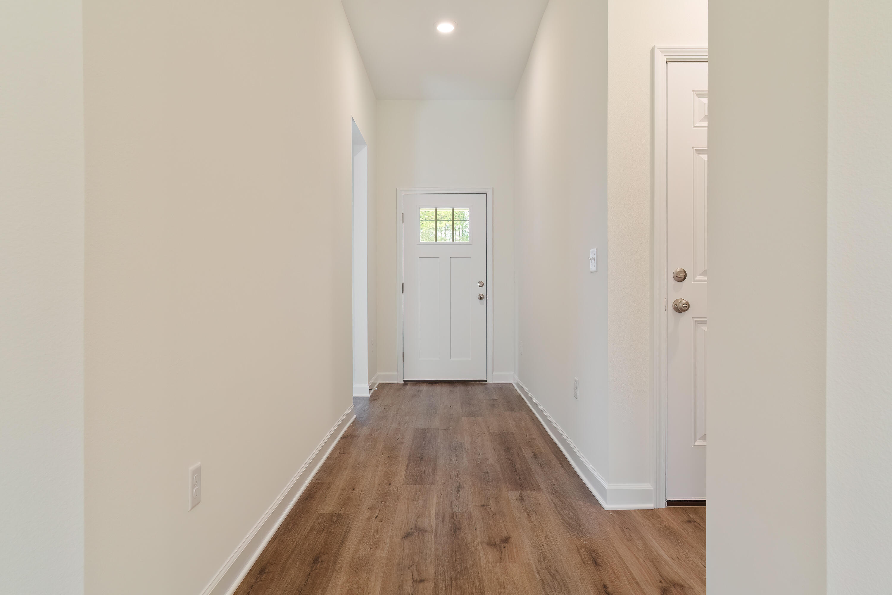 6018 Oak Hollow Way Crestview, FL 32539 - Photo 2 of 18 a view of a hallway with wooden floor