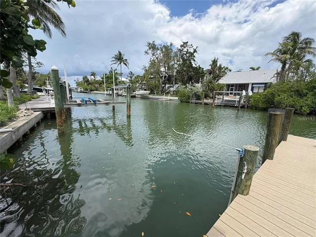a view of a lake with houses in the back