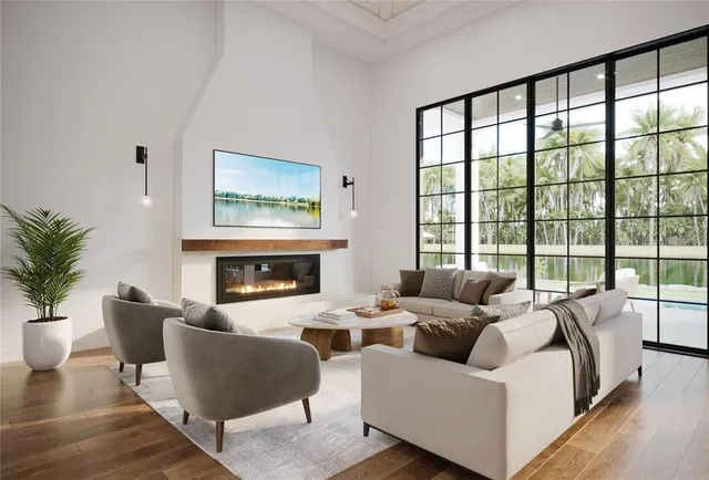 a living room with furniture large window and a fireplace