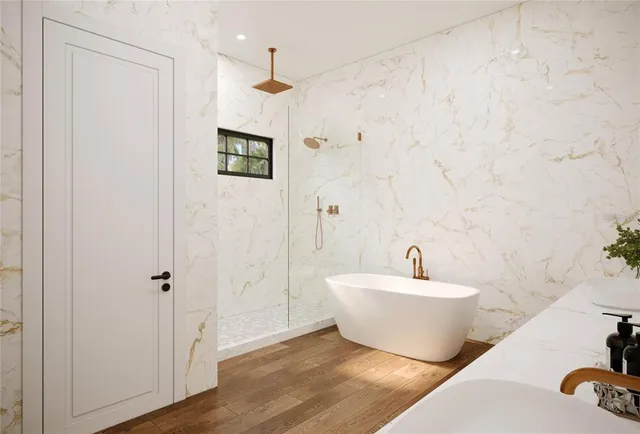 a bathroom with a bathtub and shower